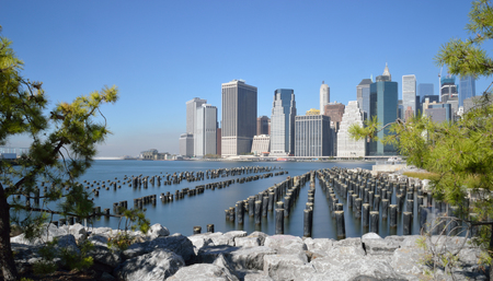 Old pier pylons and Downtown Manhattan, New York City.の写真素材