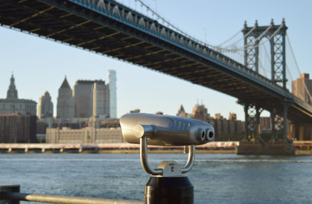 Coin-operated binoculars against a Manhattan Bridge - view from Brooklyn Bridge Park.