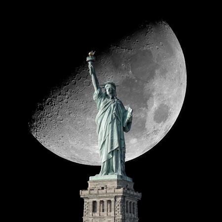 Statue of Liberty and Moon on the black night sky.の写真素材