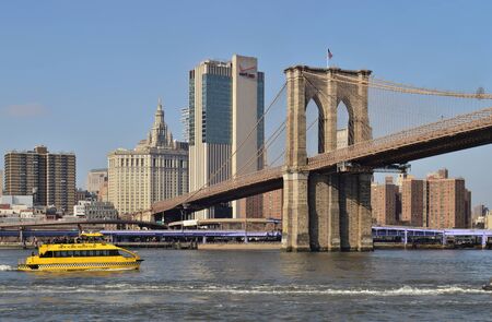 New York City, USA - February 3, 2019: New York Water Taxi ferry boat on the East River near the Brooklyn Bridge, Lower Manhattan.のeditorial素材