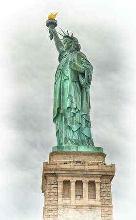 Statue of Liberty against a cloudy sky.の写真素材