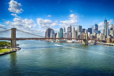 Manhattan skyline with Brooklyn Bridge at sunny day.の写真素材