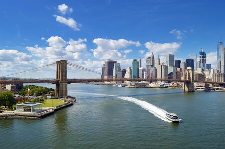 East River panorama with Brooklyn Bridge at sunny day.の写真素材