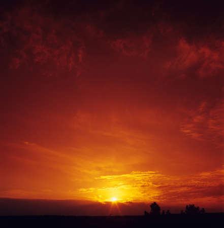 Beautiful blood-red sunset over a dark landscape. Scanned slide film. No correction.の写真素材