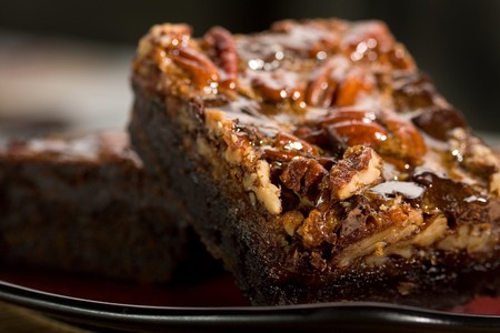 Chocolate brownies with caramel, nuts, and chocolate chunksの写真素材