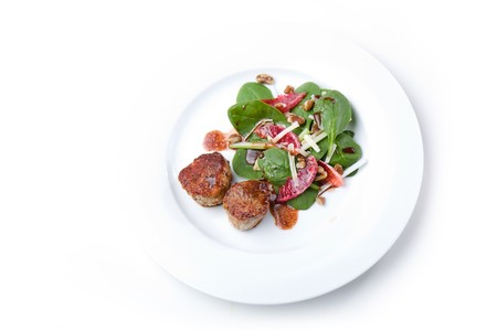 Pork Tenderloin Medallions with Spinach, Blood Orange, and Fennel Saladの写真素材