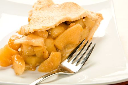 Juicy apple pie slice on square plateの写真素材