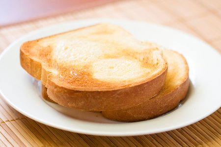 Thick sliced homemade bread broiled with butter