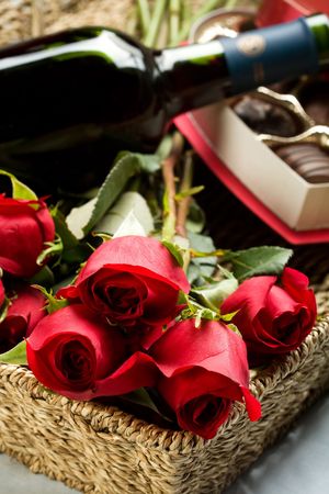 Roses, Wine and Chocolates in a large wicker trayの写真素材