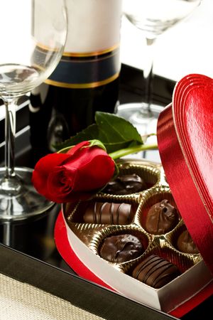Valentine's day roses, candies and wine on black trayの写真素材