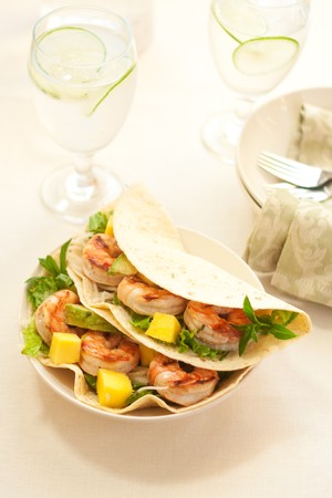 Delicious Spicy shrimp taco with lettuce jimaca salad mano and avocadoの写真素材
