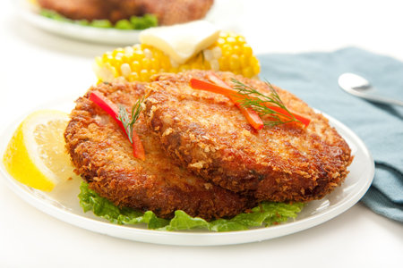 Large dinner sized salmon croquettes served with corn