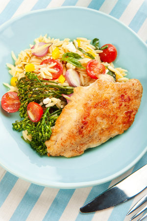 Chicken Breast with orzo pasta salad and roasted broccoliniの写真素材