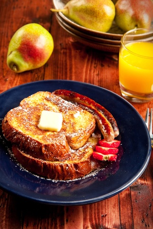 Sausage accompanies French toast in a delicious breakfastの写真素材