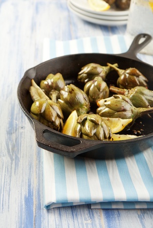 Baby artichokes roasted simply and served with lemonの写真素材