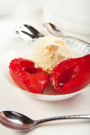 Wine poached pears with vanilla ice creamの写真素材