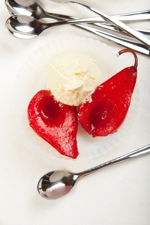 Wine poached pears with vanilla ice creamの写真素材