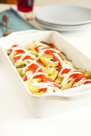 Stuffed pasta shells in white baking dishの写真素材