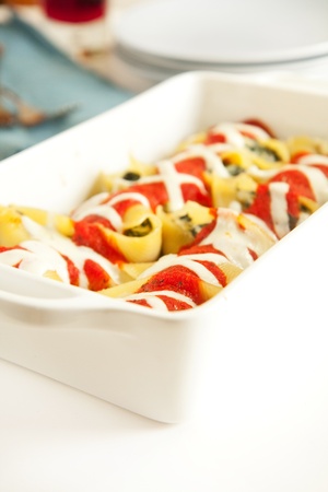 Stuffed pasta shells in white baking dishの写真素材