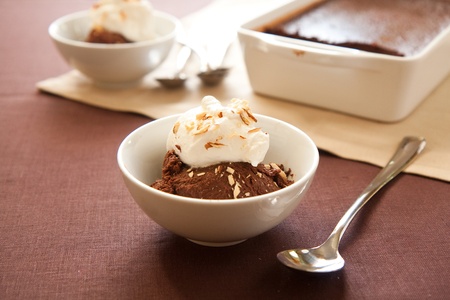 Italian dessert chocolate sformato topped with whipped cream and almondsの写真素材