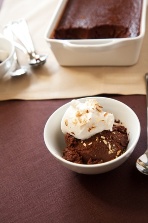 Italian dessert chocolate sformato topped with whipped cream and almondsの写真素材