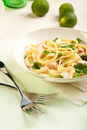 Salmon fettuccine with peas a creamy sauce and parsleyの写真素材