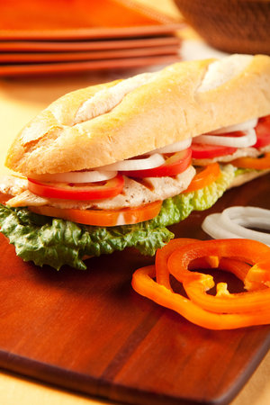 Grilled chicken sandwich with orange pepeprs, tomato, lettuce and onionsの写真素材