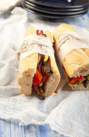 Tasty grilled vegetarian submarine sandwich with portobello mushroom, peppers, onions, zucchini and tomatoの写真素材