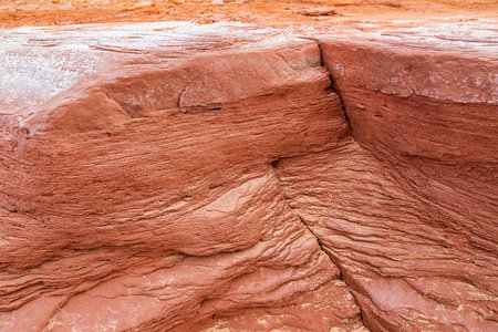 At Cavendish beach, on Canada's Prince Edward Island, the flat red sandstone has been weathered by...