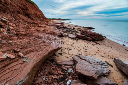 Red and Turquoise  sandstone cliff and rocks at Cavendish beach of Prince Edward Island