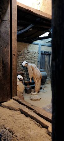A couple in museum of national folklore museum. A still of Traditional Korean people in ancient traditional korean household.の写真素材