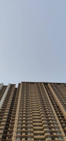 A high rise apartment building reaching for the sky in Delhi, Indiaの写真素材