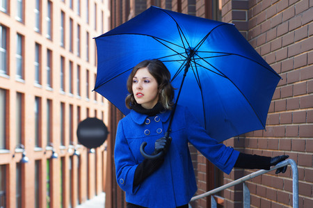 Fashion shoot of young attractive woman with umbrellaの写真素材
