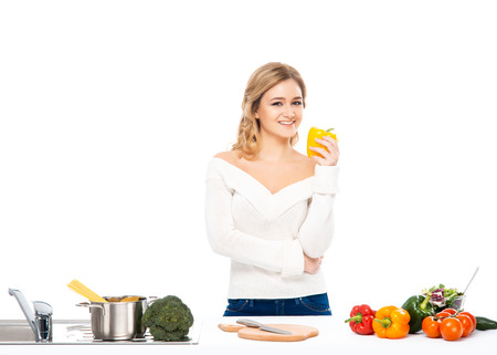 Young and beautiful housewife woman cooking in a kitchenの写真素材