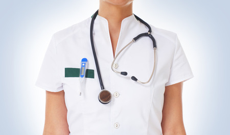 Young attractive doctor over blue backgroundの写真素材