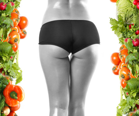 Belly of beautiful young female sportsman over dieting backgroundの写真素材