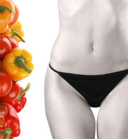 Belly of beautiful young female sportsman over dieting backgroundの写真素材