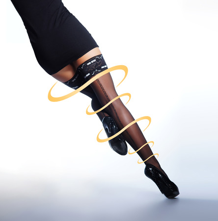 Beautiful female legs in stockings isolated on whiteの写真素材