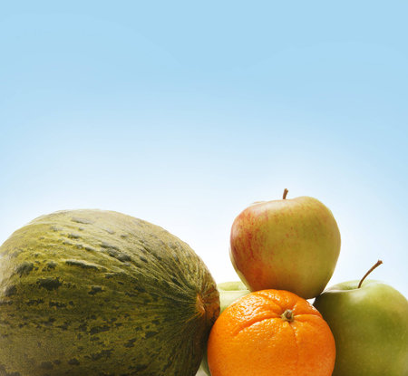 Pile of different fruits and vegetables over blue backgroundの写真素材