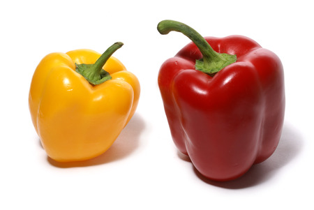 Yellow sweet and red bitter peppers isolated on white backgroundの写真素材