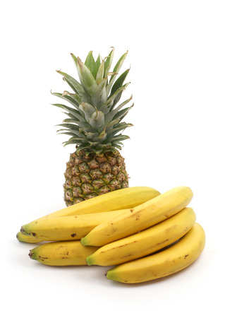 Bananas and pineapple isolated on whiteの写真素材