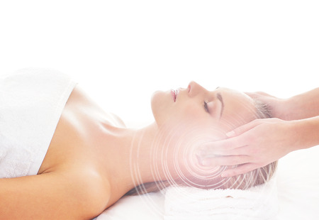 Young, beautiful and healthy woman getting alternative massage treatment (composition with the glares)の写真素材