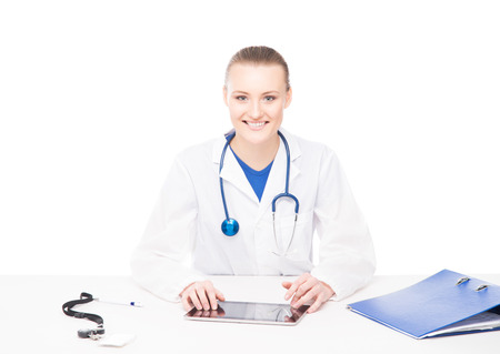 Young, professional and cheerful female doctor working in office isolated on whiteの写真素材