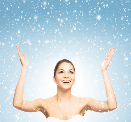 Portrait of young and beautiful teenage winner girl over winter backgroundの写真素材