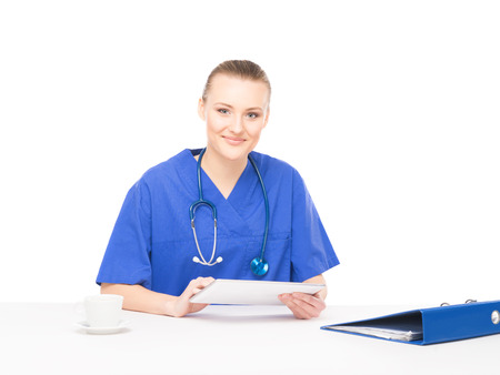 Young, professional and cheerful female doctor working in office isolated on whiteの写真素材