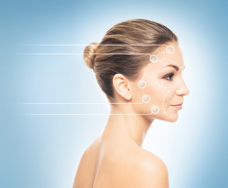 Close-up portrait of young, fresh and natural woman with the dotted arrows (spa, surgery, face lifting and make-up concept)の写真素材