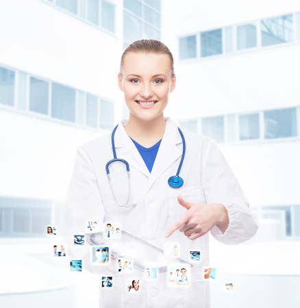 Young, professional and cheerful doctor woman with a tablet. Medical technology and futuristic medicine concept.の写真素材