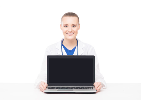Young, professional and cheerful female doctor isolated on whiteの写真素材