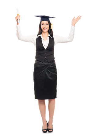 Young, beautiful and happy graduate girl holding degree diploma and smiling isolated on whiteの写真素材