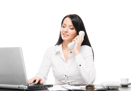 Young and attractive business woman working in office isolated on whiteの写真素材